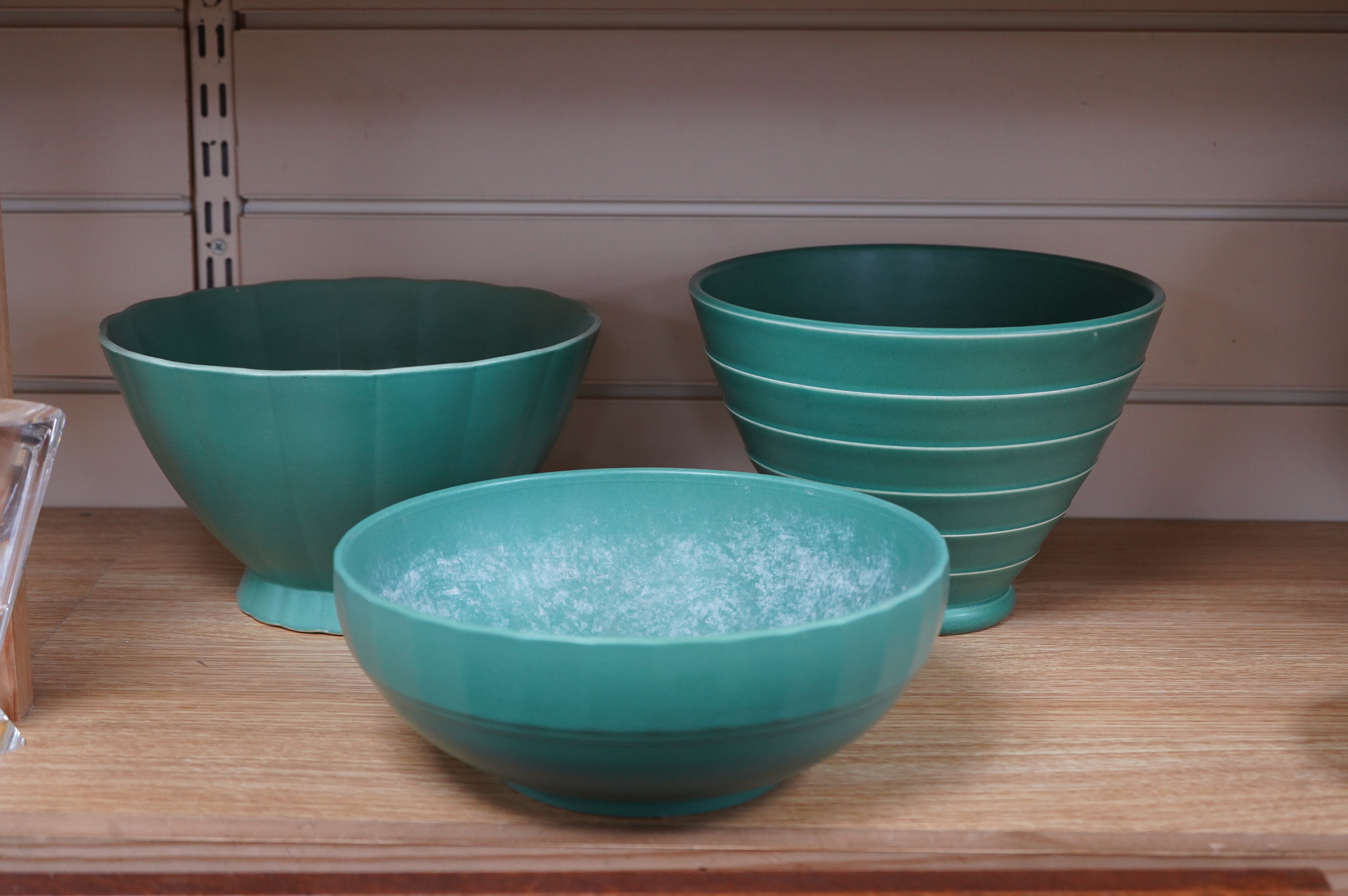 Keith Murray for Wedgwood, three green glazed bowls to include a ribbed example, largest 24cm in diameter